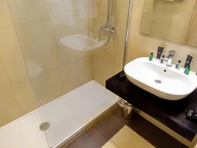 a bathroom with a sink and a shower at San Paolo Palace Hotel in Palermo