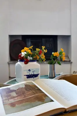a book on a table with flowers on top of it at Villa Tramonto in Macari
