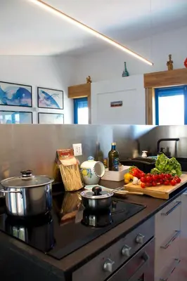 a kitchen with a stove with vegetables on the counter at Villa Tramonto in Macari