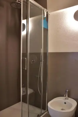 a glass shower in a bathroom with a sink at Villa Tramonto in Macari