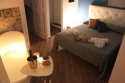 a bedroom with a bed with a tray of food on it at Dimore de La Rosa in Palermo