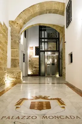 a lobby with a sign on the floor of a building at Casa Petra ai Quattro Canti in Palermo