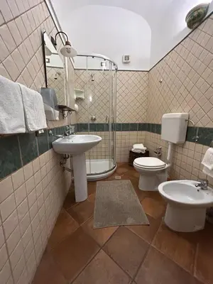 a bathroom with a sink and a toilet and a mirror at B&B Cinisi Vacanze in Cinisi