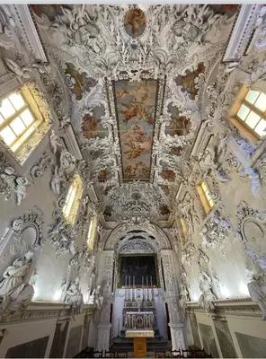 a church with a ceiling with paintings on it at Lomarchi Holiday Home in Carini