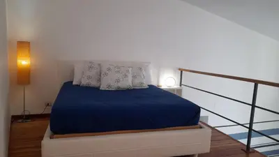 a bedroom with a bed with blue sheets and pillows at Casa Ranieri Palermo in Palermo
