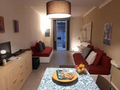 a living room with a red couch and a table at Casa Ranieri Palermo in Palermo