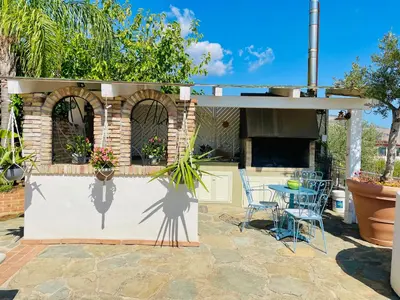 a patio with a table and chairs next to a building at B&B Sole e Luna in Palermo