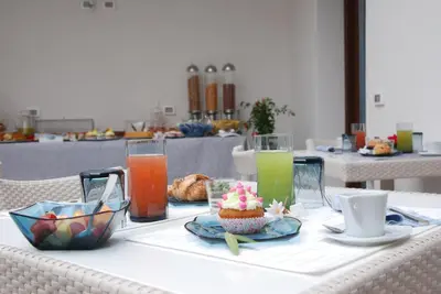 a table with drinks and a cupcake on it at Ciuri Di Mari in San Vito lo Capo