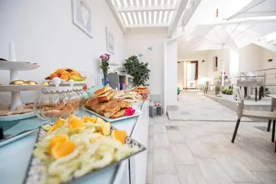 a buffet line with plates of food on display at Ciuri Di Mari in San Vito lo Capo