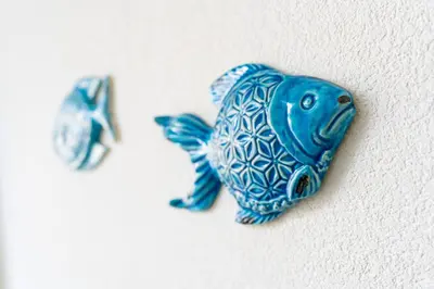 a blue figurine of a fish on a wall at Ciuri Di Mari in San Vito lo Capo