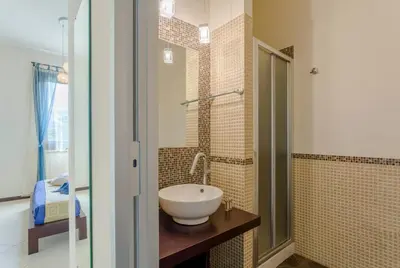 a bathroom with a sink and a shower at Karma B&B in San Vito lo Capo