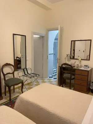 a bedroom with a bed and a desk and a mirror at 301B&B in Palermo