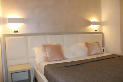 a bedroom with a bed with two pillows on it at Artemisia Palace Hotel in Palermo