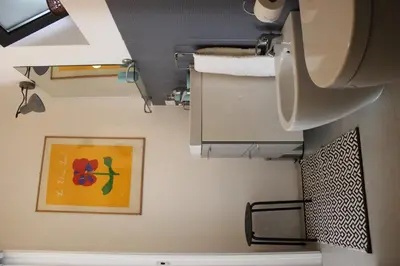 a bathroom with a toilet and a picture on the wall at Nel Giardino degli Agrumi in Palermo