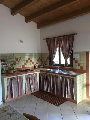 a kitchen with a sink and a window at Lovely Cottage in Castellammare del Golfo
