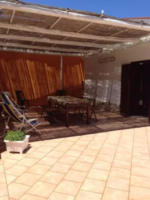 a patio with a table and chairs on it at Lovely Cottage in Castellammare del Golfo