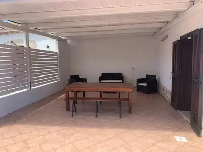 a room with a wooden table and chairs in it at Lovely Cottage in Castellammare del Golfo