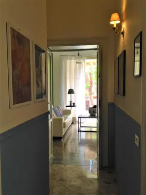 a hallway with a living room with a couch at A Casa di Amelie in Palermo