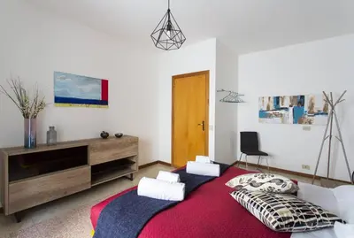 a living room with a large red rug at BB4U Apartments and Terrace in Palermo