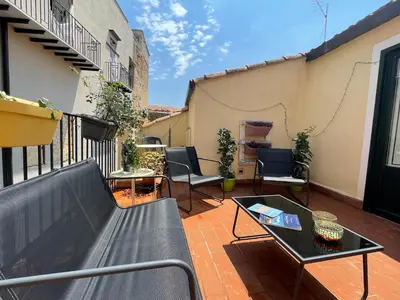 a balcony with a bench and a table and chairs at BB4U Apartments and Terrace in Palermo