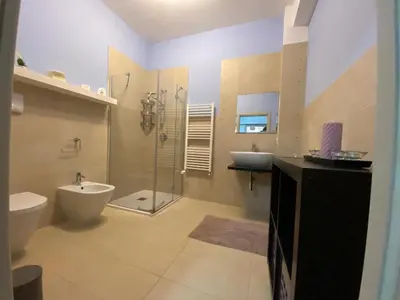 a bathroom with a shower and a toilet and a sink at Villa Ruffino in Balestrate