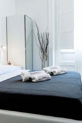a bedroom with a bed with two pillows on it at L'Opera Buffa in Palermo