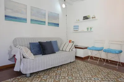 a living room with a couch and two stools at Case di Maria in Castellammare del Golfo