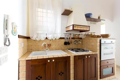 a kitchen with a sink and a stove at Oasi Centrale in Palermo