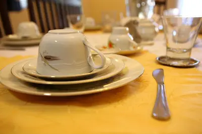 a table with a tea cup and plates and a spoon at Art Lincoln in Palermo
