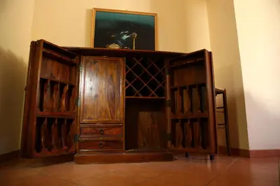 a wooden wine cabinet in a room at Art Lincoln in Palermo