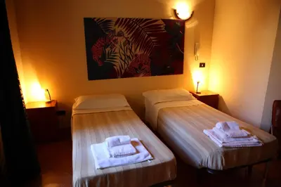 two beds in a room with towels on them at Art Lincoln in Palermo