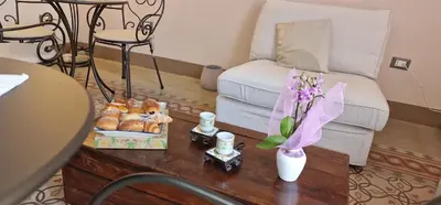a living room with a table with pastries and a couch at Eureka in Palermo