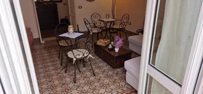 a living room with chairs and a table with a cake on it at Eureka in Palermo