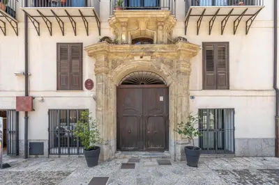 an entrance to a building with a wooden door at Cala Loft by Wonderful Italy in Palermo