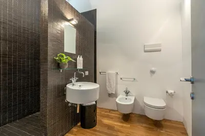 a bathroom with a sink and a toilet at Cala Loft by Wonderful Italy in Palermo