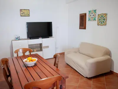 a living room with a table and a couch at Orlando Bayview in Balestrate