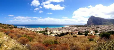 a view of a city and the ocean from a hill at Appartamento Il Pomodoro in San Vito lo Capo