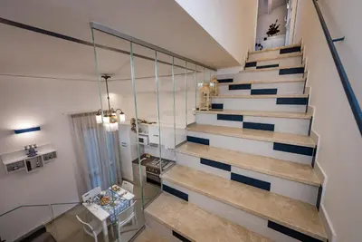 a staircase in a house with a glass wall at Le Perle del Golfo in Castellammare del Golfo