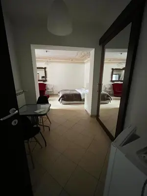 a bedroom with a bed and a table and a mirror at Lercarappart in Lercara Friddi