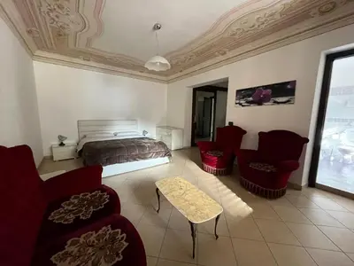 a bedroom with a bed and some chairs and a table at Lercarappart in Lercara Friddi