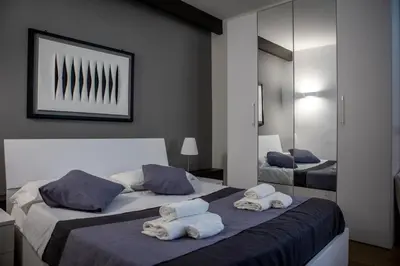 a bedroom with two beds with towels on them at Palermo al Centro - Appartamento Vittorio in Palermo