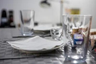 a table with a plate and glasses on it at Palermo al Centro - Appartamento Vittorio in Palermo
