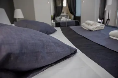two beds with pillows on them in a bedroom at Palermo al Centro - Appartamento Vittorio in Palermo