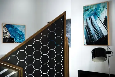 a staircase with two paintings and an accordion on the wall at Trikeles in Palermo