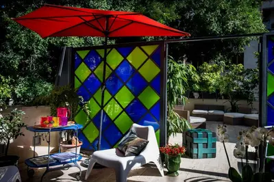 a red umbrella sitting on top of a patio at Trikeles in Palermo