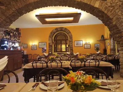 a restaurant with tables and chairs in a room at Albergo Ristorante Pizzeria Del Viale in Palazzo Adriano