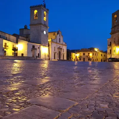 an empty street in a town at night at Albergo Ristorante Pizzeria Del Viale in Palazzo Adriano