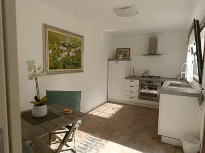 a kitchen with a table and a sink and a counter at B & B Villa Flora in Mondello