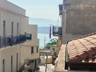 a view of the ocean from between two buildings at Via Siracusa 5 in Castellammare del Golfo