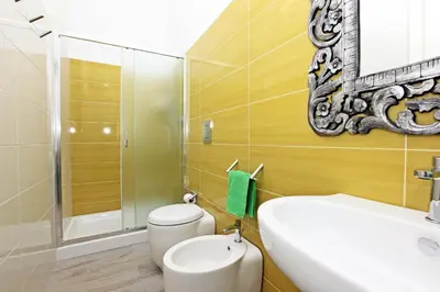 a bathroom with a toilet and a sink and a mirror at Via Siracusa 5 in Castellammare del Golfo